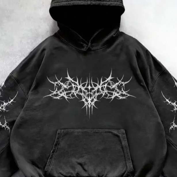 Black hoodie with white intricate design on a light gray background
