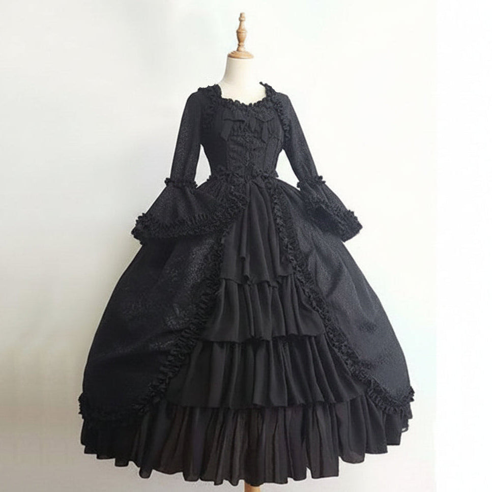 A black Victorian-style ball gown displayed on a dress form mannequin against a plain off-white background.