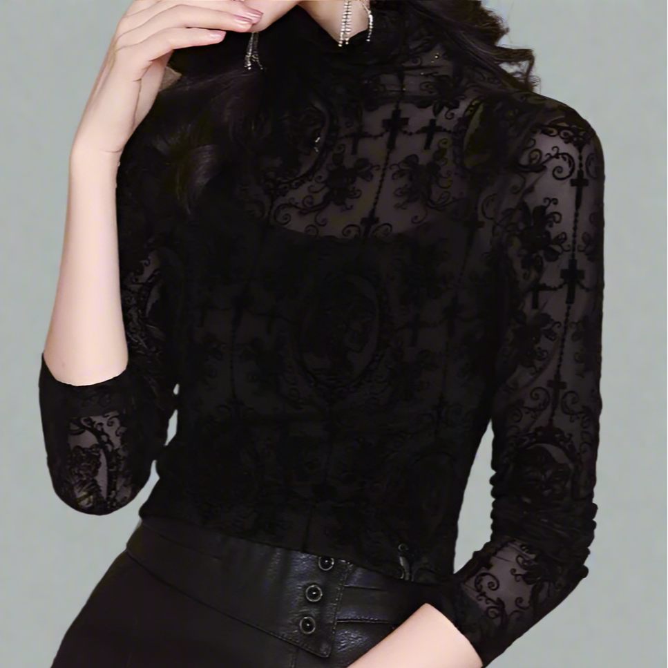 Black lace long-sleeve top worn by a person against a gray background