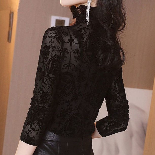 Black lace blouse worn by a person with a neutral background