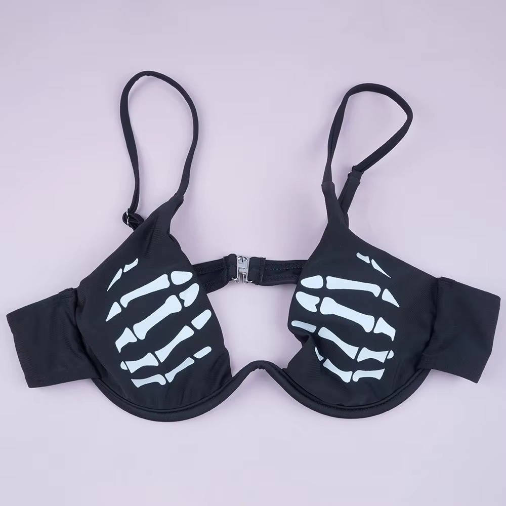 Black bra with skeleton hand design on a light gray background