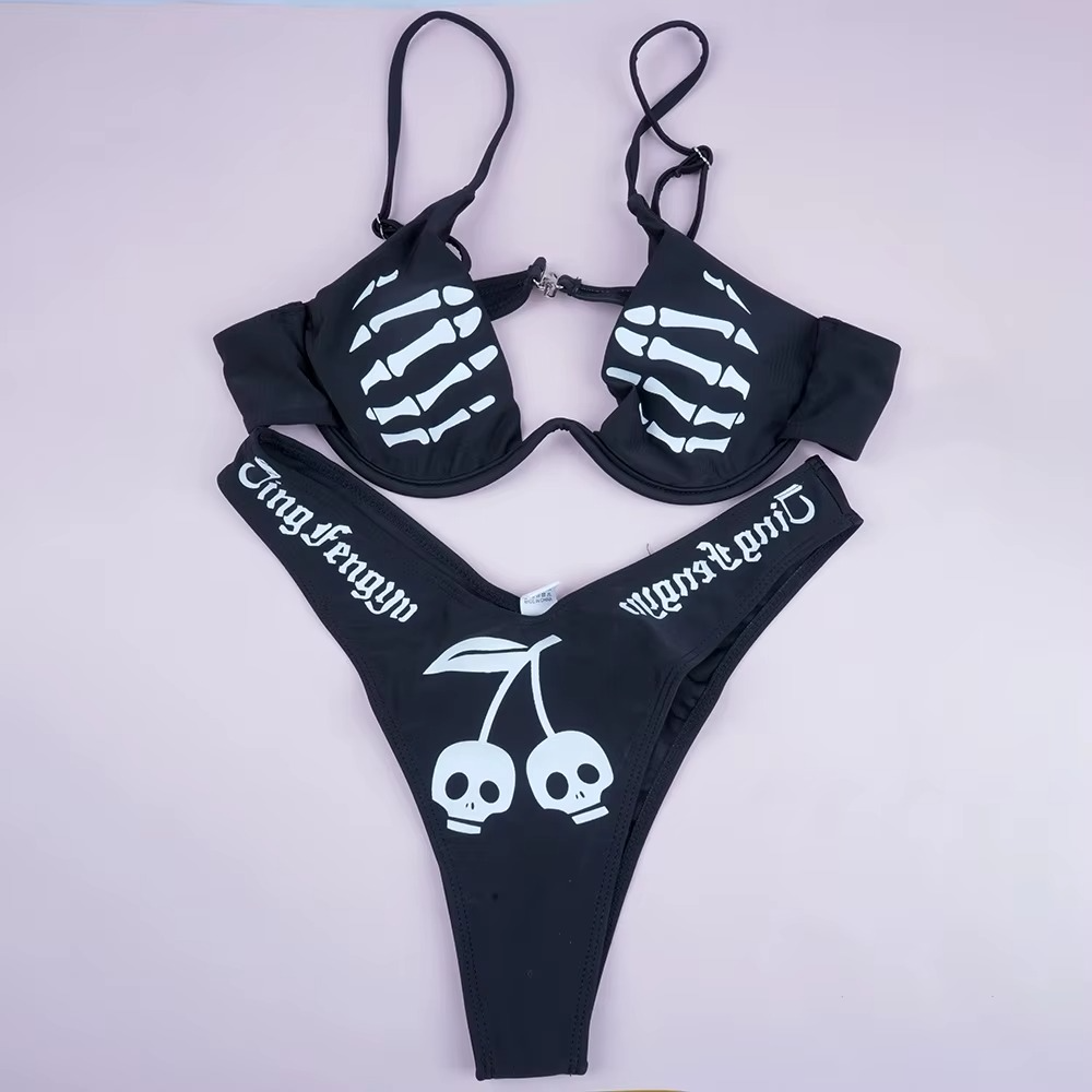 Black skeleton-themed bikini set with white designs on a light gray background