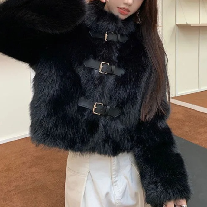 Person wearing a black fur coat in a store setting